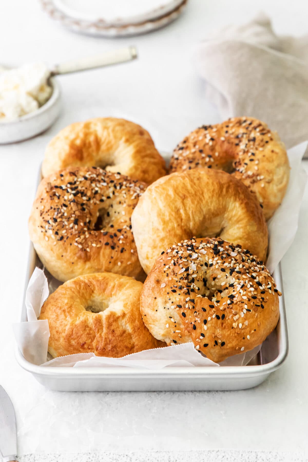 fresh air fryer bagels on a metal baking pan.