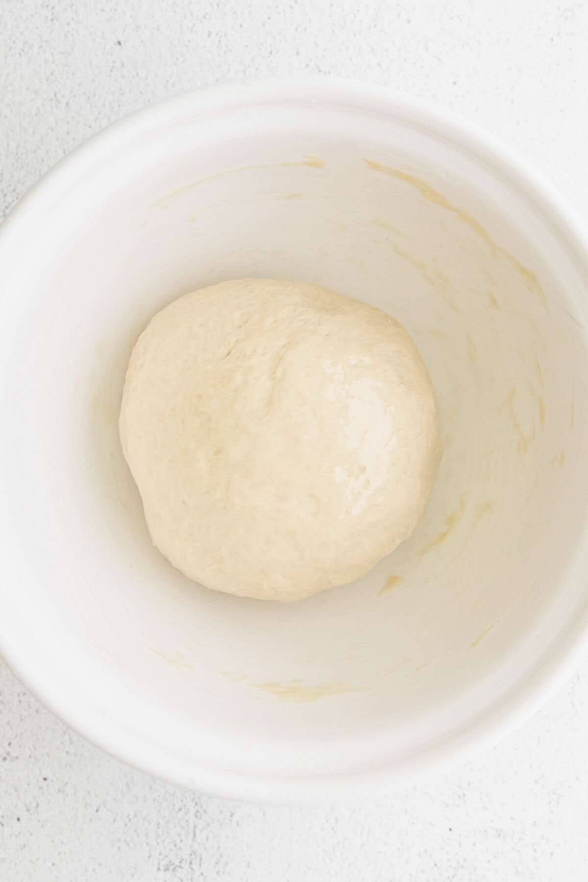 bagel dough in a white bowl.