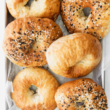 6 air fryer bagels on a metal tray.