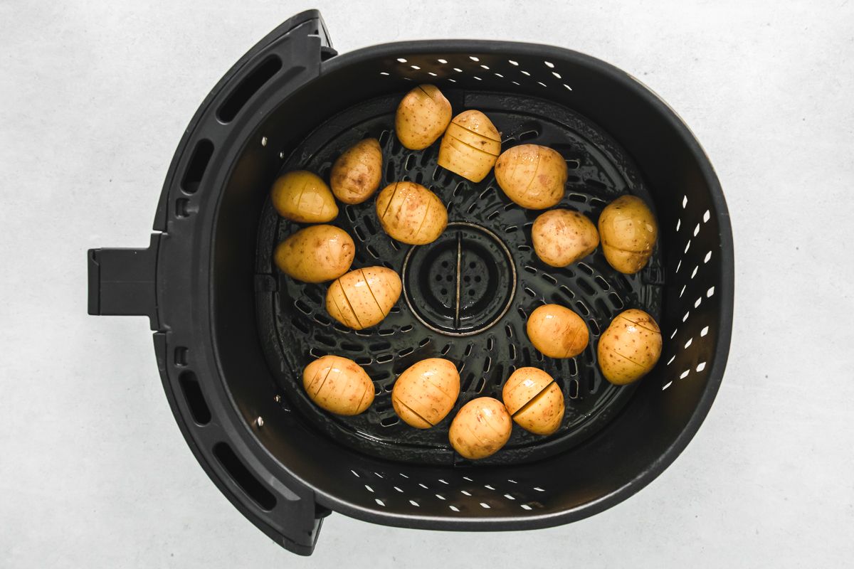 mini hasselback potatoes in air fryer basket.