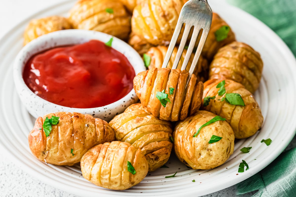 fork grabbing a mini hasselback potato.