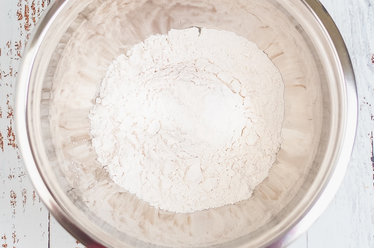 dry ingredients for peanut butter cookies in a stainless steel bowl.