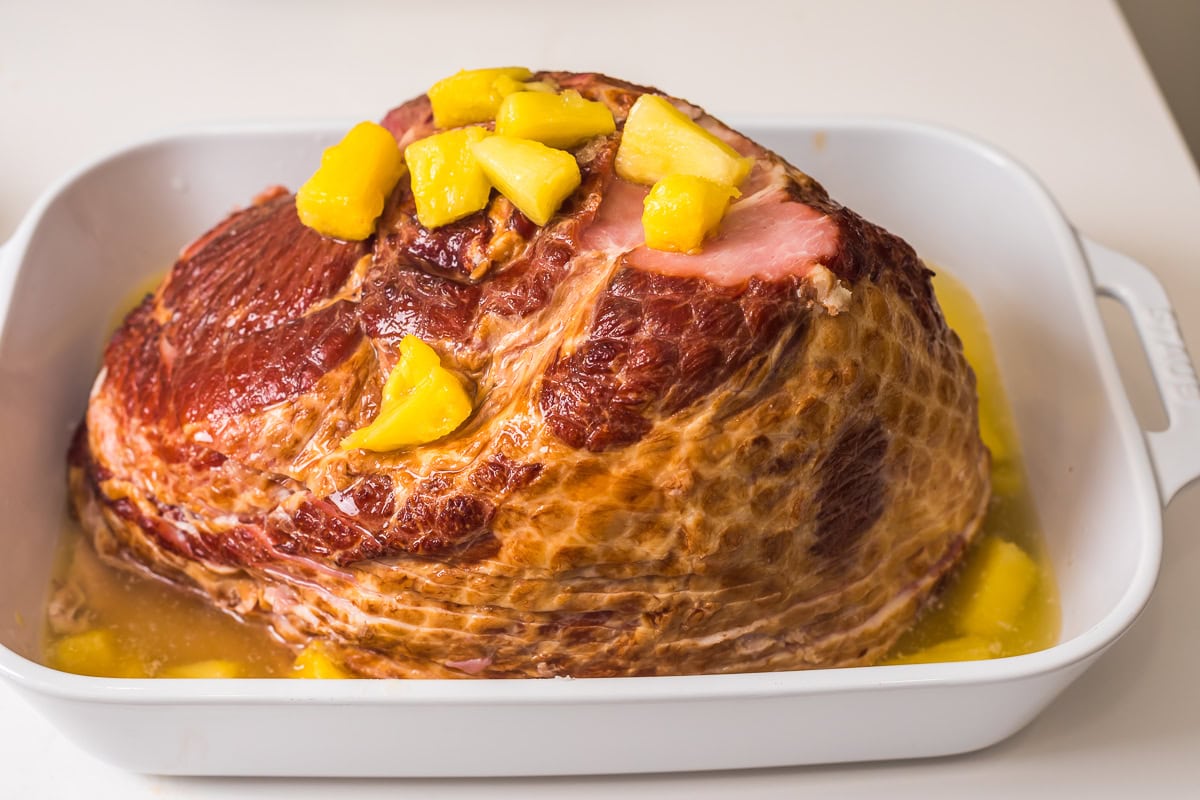 precooked spiral ham in casserole dish ready to bake.