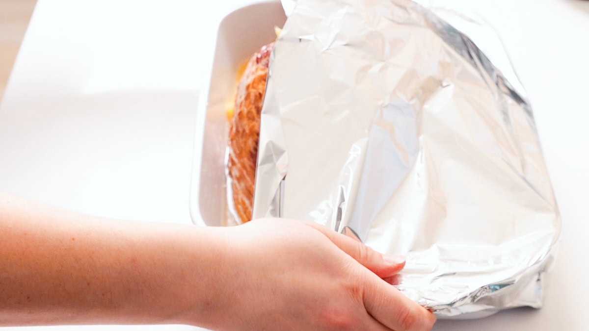 wrapping casserole dish with foil to bake ham.