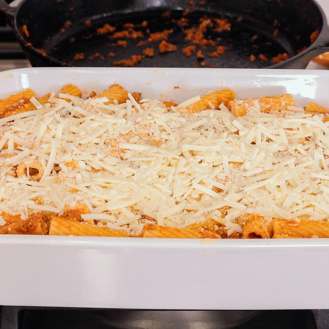 uncovered baked ziti ready to bake in a white casserole dish.