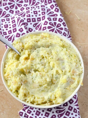 Kid Friendly Cheesy Garlic Mashed Potatoes are the perfect holiday side dish that everyone will enjoy. Vegetarian and delicious!