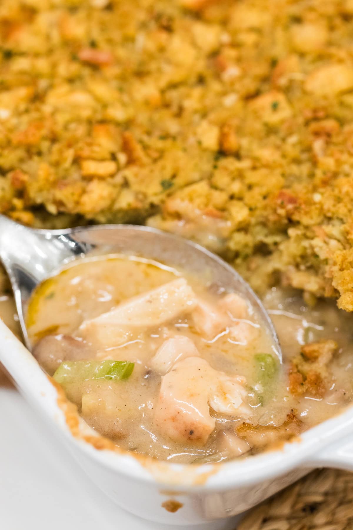 spoon scooping chicken and stuffing casserole.