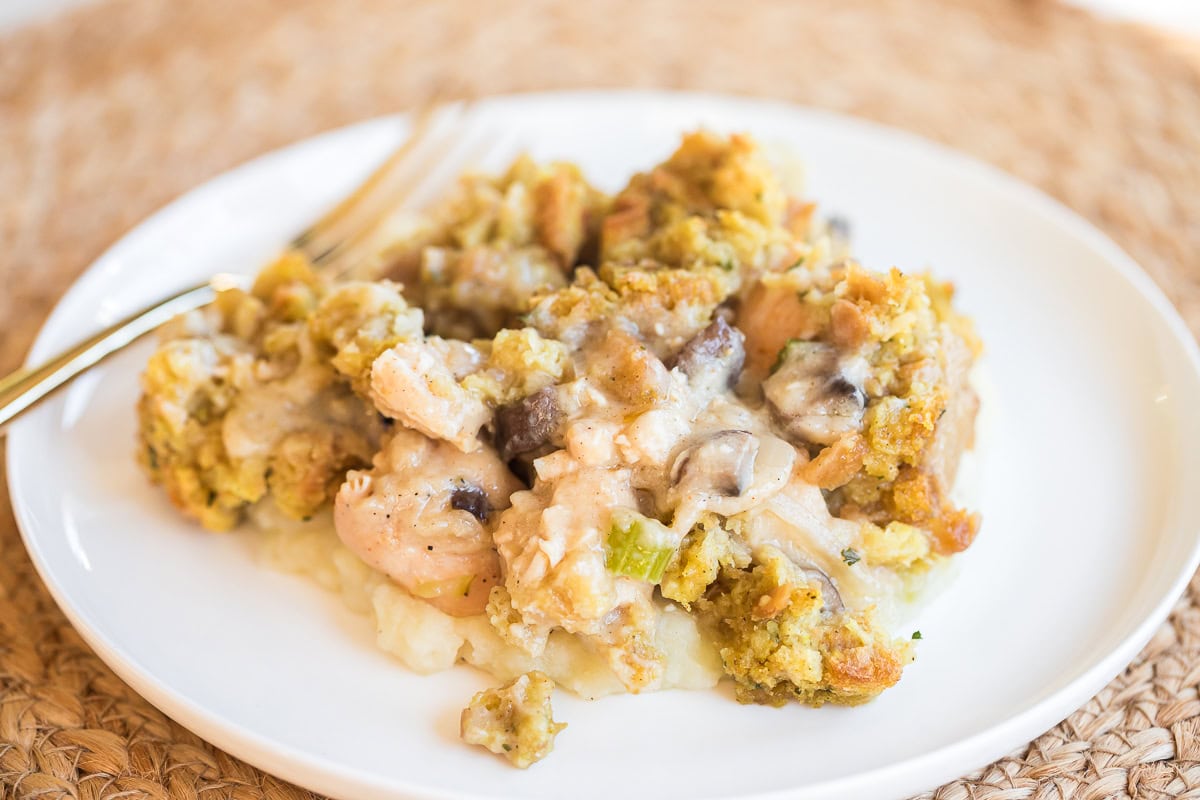 white plate with chicken and stuffing casserole on it.