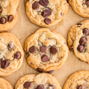 chocolate chip cookies on a parchment lined baking sheet