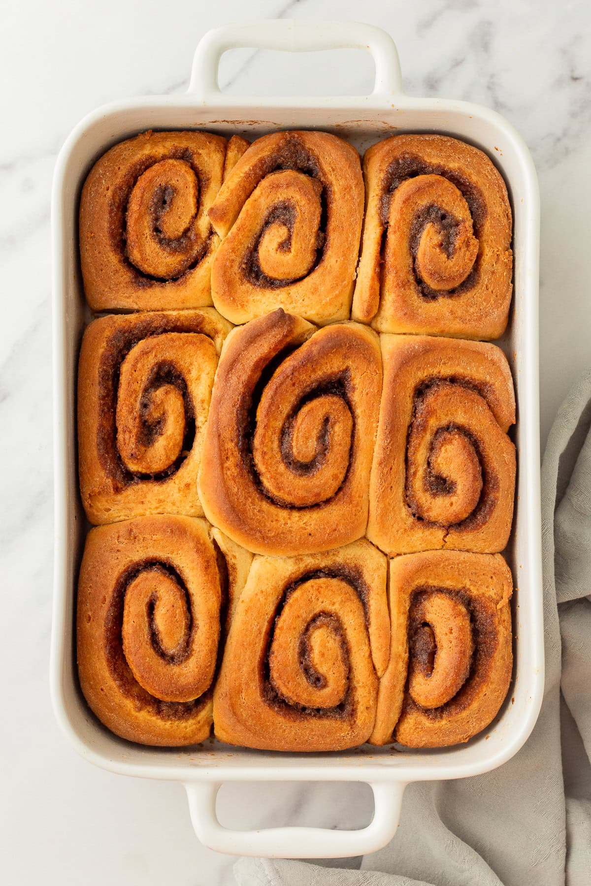 fresh baked cinnamon rolls in a casserole dish.