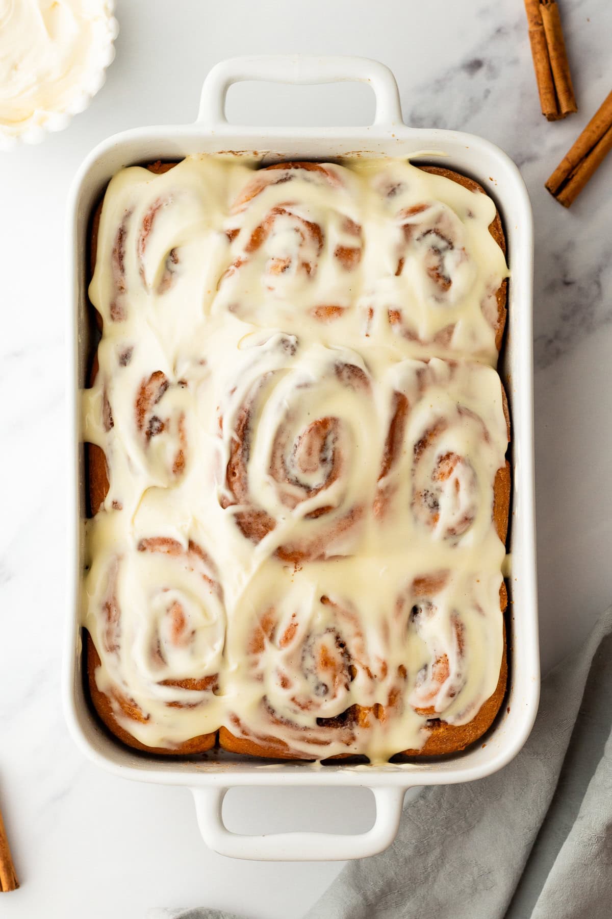 overhead photo of homemade cinnamon rolls in a baking dish.