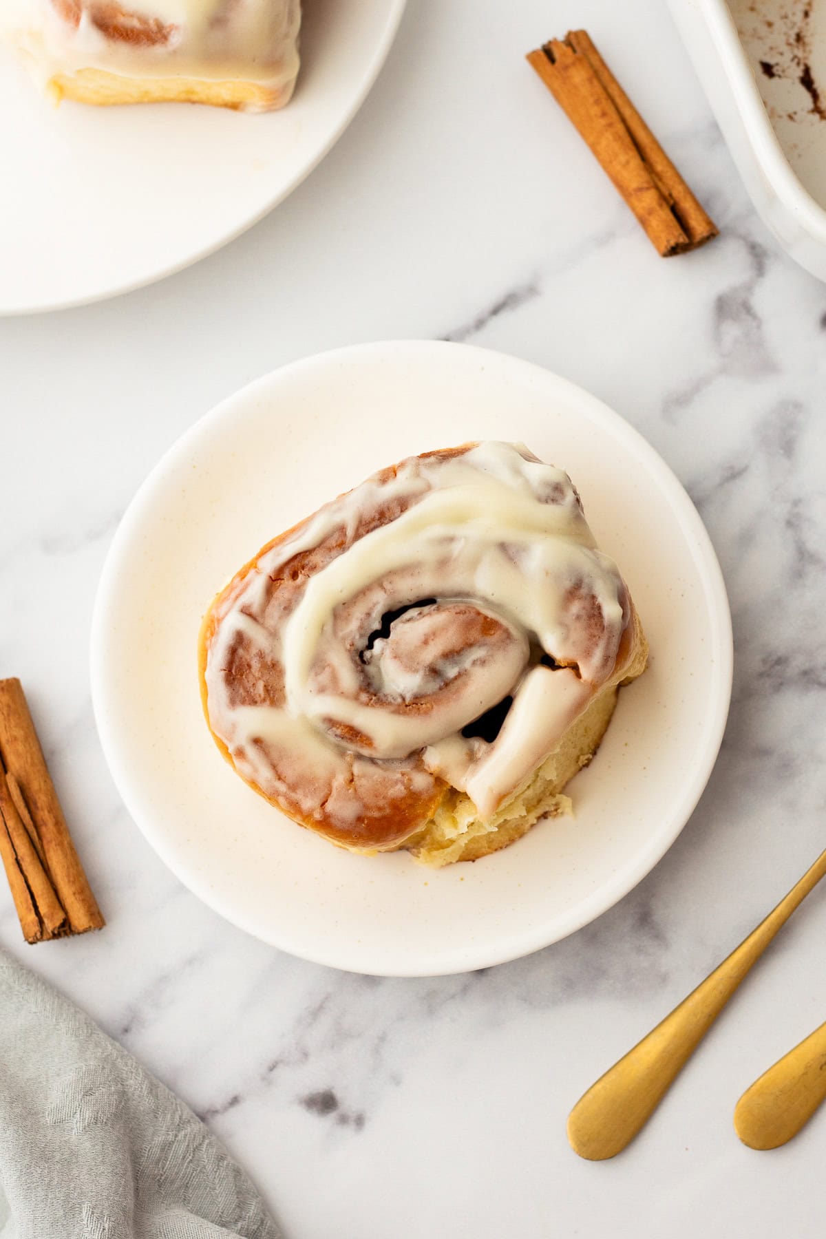 overhead photo of a cinnamon roll on a plate.