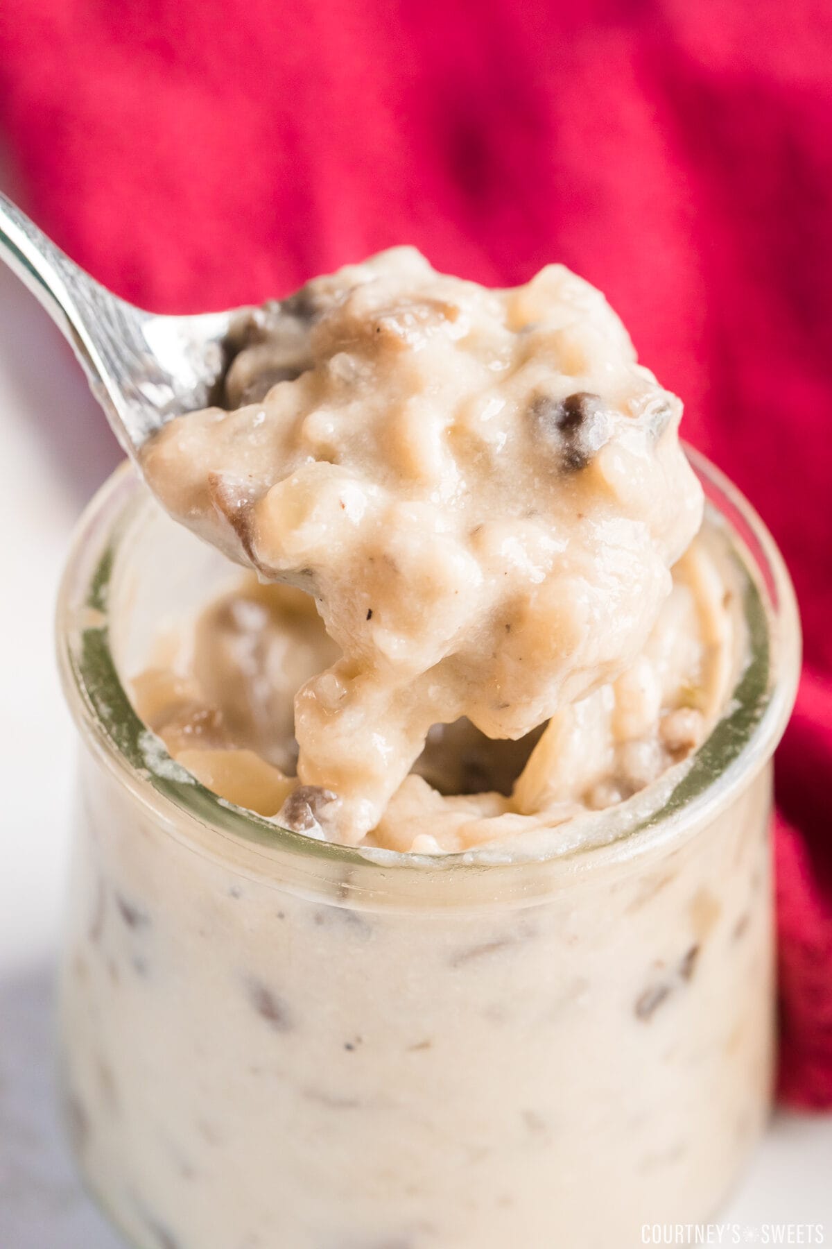 condensed cream of mushroom soup in a glass jar with spoon scooping it out.