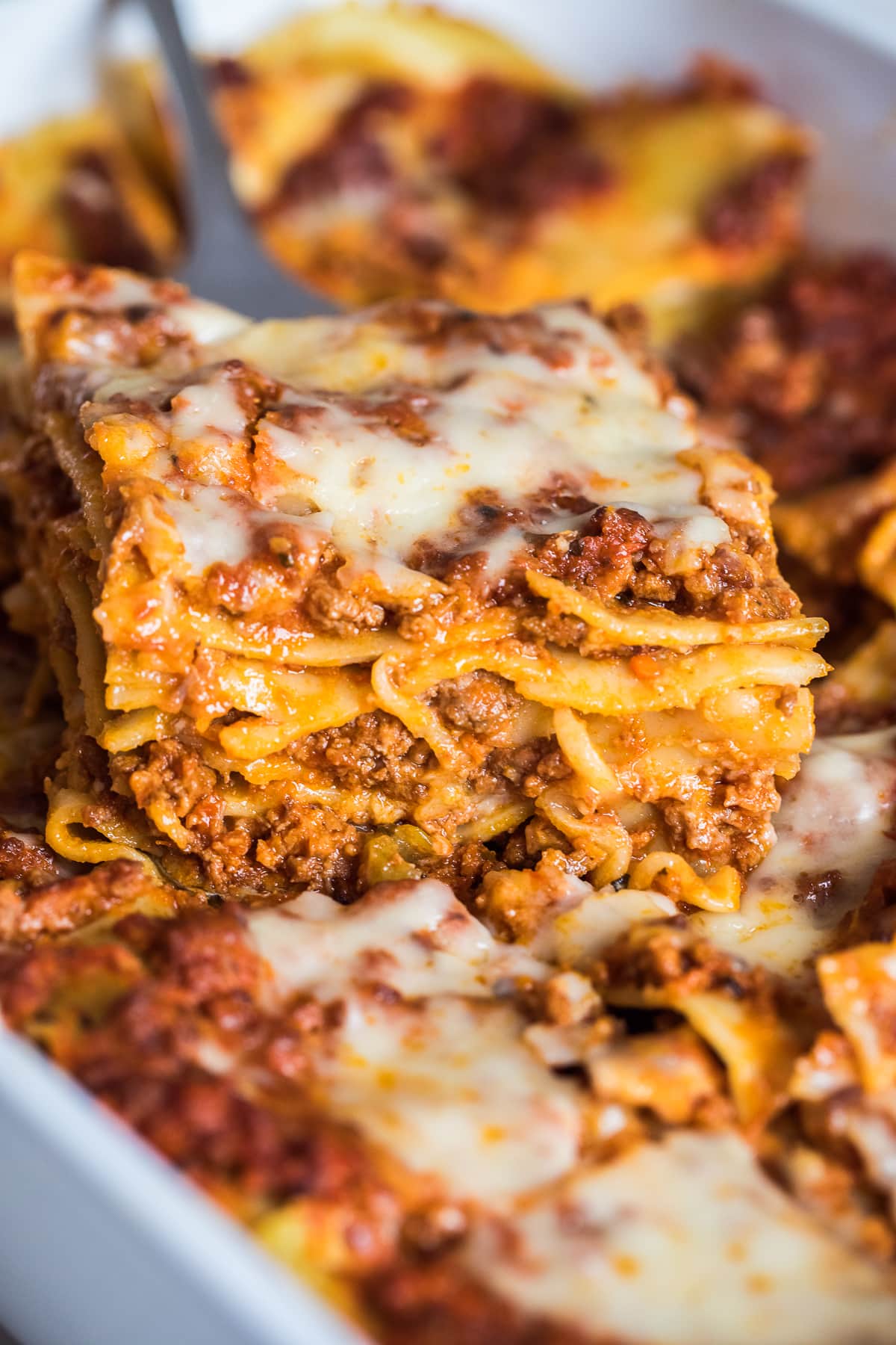 close up of a slice of dairy free lasagna without ricotta showing lasagna layers.