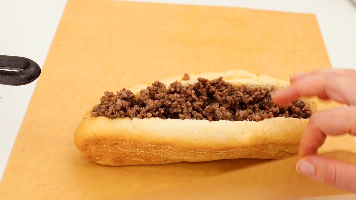 ground beef cheesesteak on a piece of parchment paper.