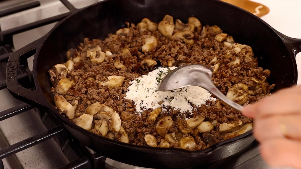 flour and seasonings added to ground beef mixture in skillet.