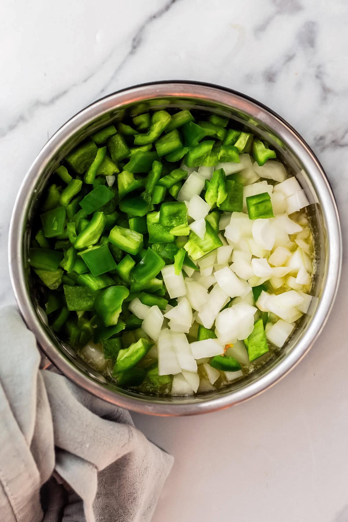 saucepan with melted butter, onions, and peppers.