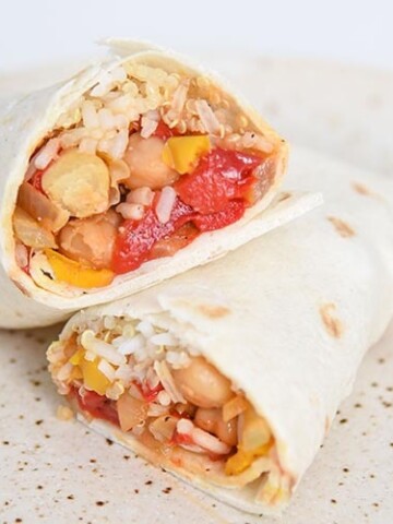 This healthy burrito recipe is not only filling, but it's also vegan! Filled with peppers, onions, chickpeas, seasoning and quinoa rice.