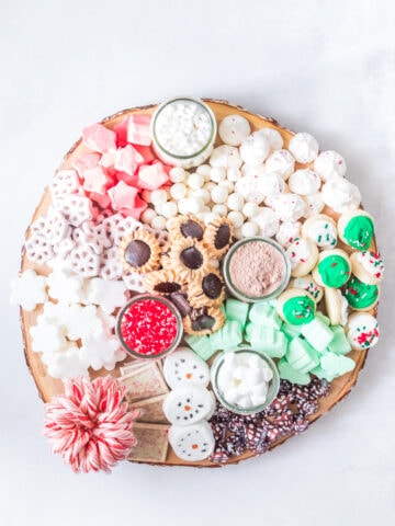 overhead photo of hot chocolate charcuterie board with various sweets and treats