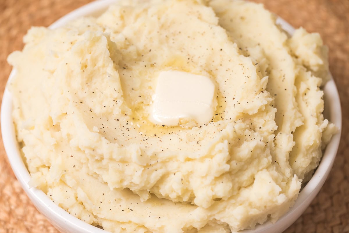 instant pot mashed potatoes with a tab of butter on top.