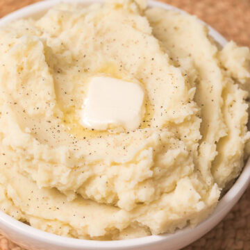 instant pot mashed potatoes in a bowl with a tab of butter.