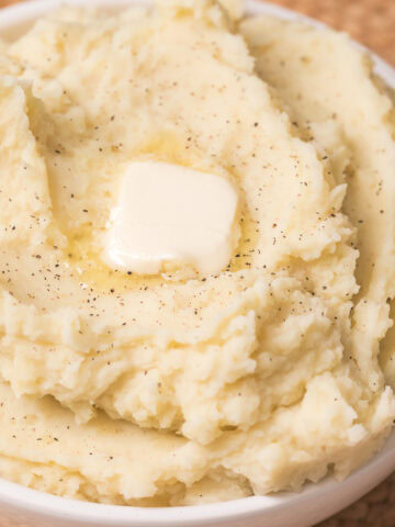 instant pot mashed potatoes in a bowl with a tab of butter.