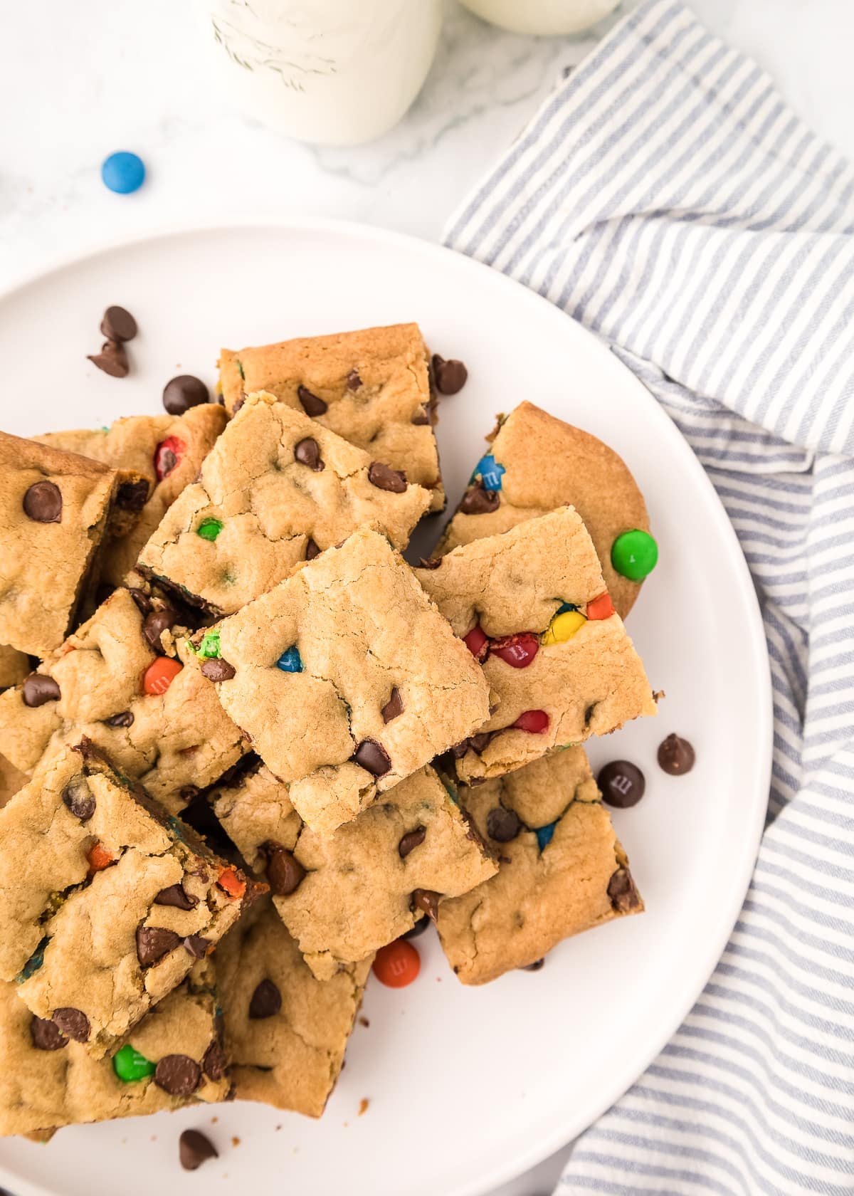 m&m cookie bars on a white plate.