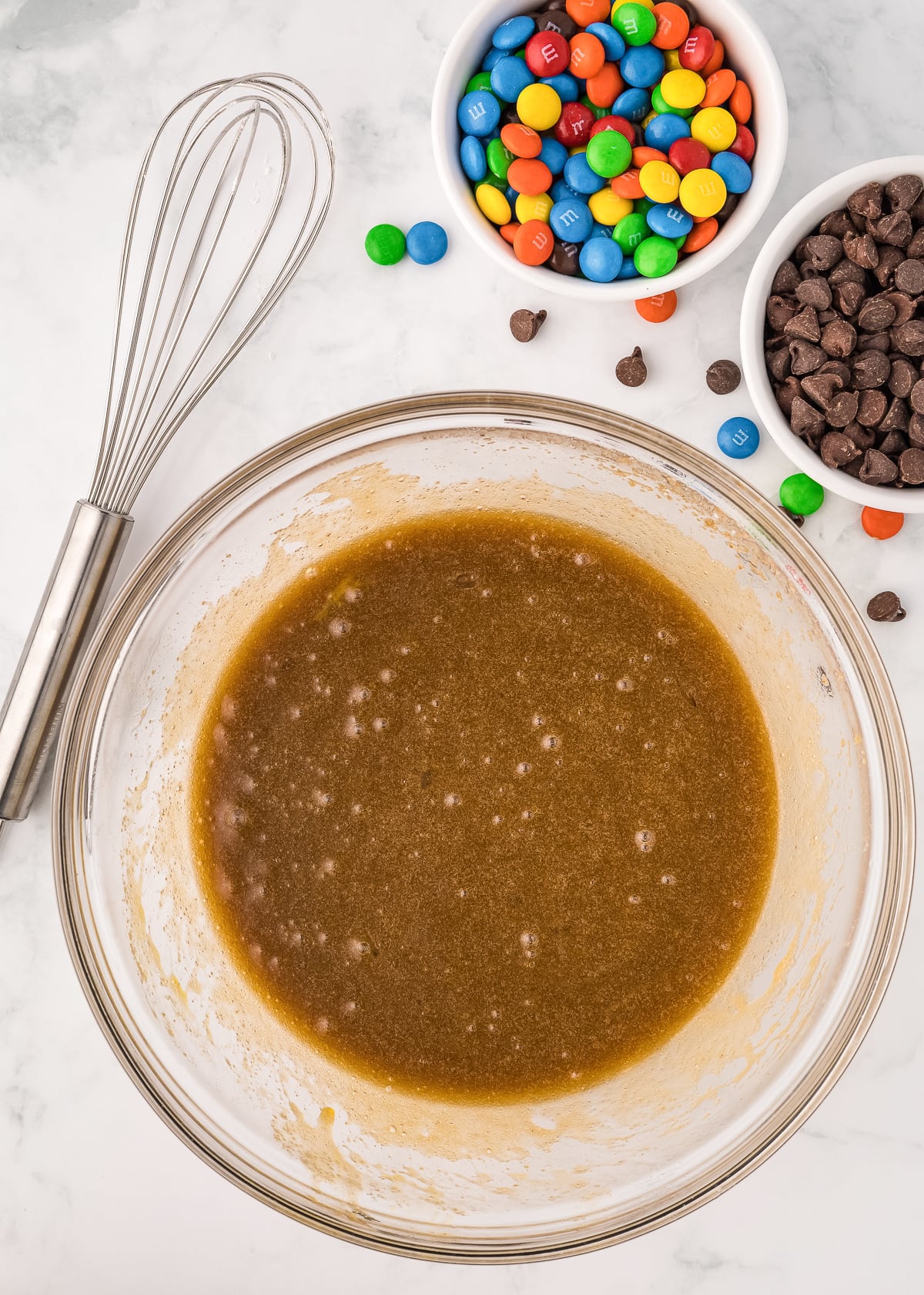 sugar and butter mixture in a glass bowl with eggs and vanilla combined.