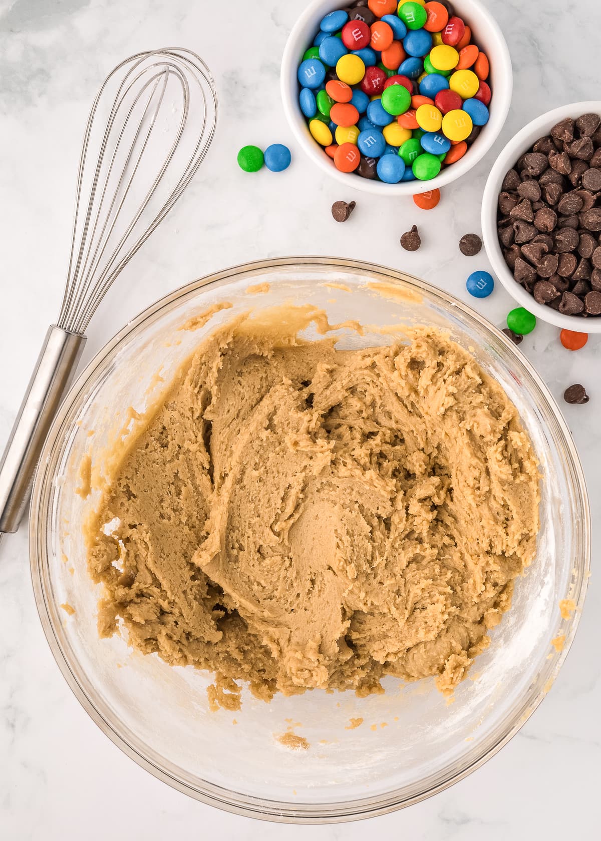 cookie dough batter mixed in a glass bowl.