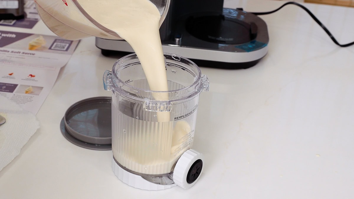 pouring vanilla ice cream base into the ninja swirl pint.