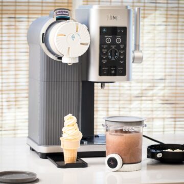 Ninja Swirl full review showing vanilla soft serve in an ice cream cone with a ninja swirl pint filled with chocolate soft serve ready to spin and the ninja swirl machine on the countertop.