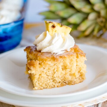 pineapple poke cake slice on a plate