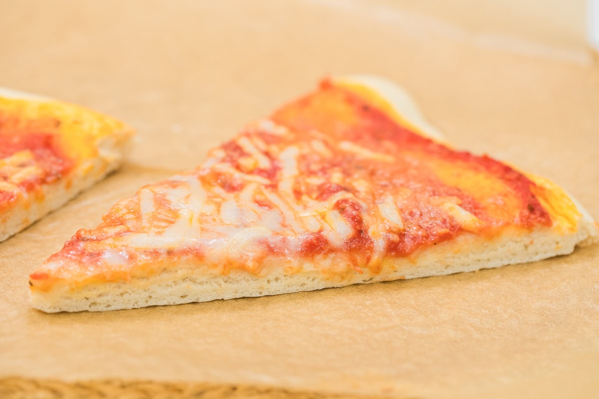 picture showing pizza slice focusing on the rise and dough.