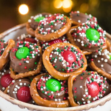 rolo pretzles with m&ms and sprinkles in a bowl