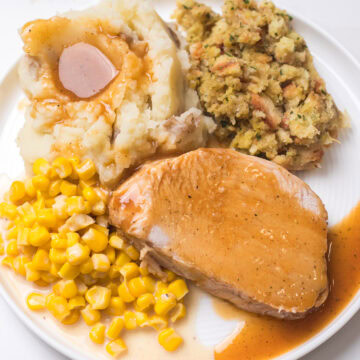 slow cooker boneless turkey breast on a plate with sides.