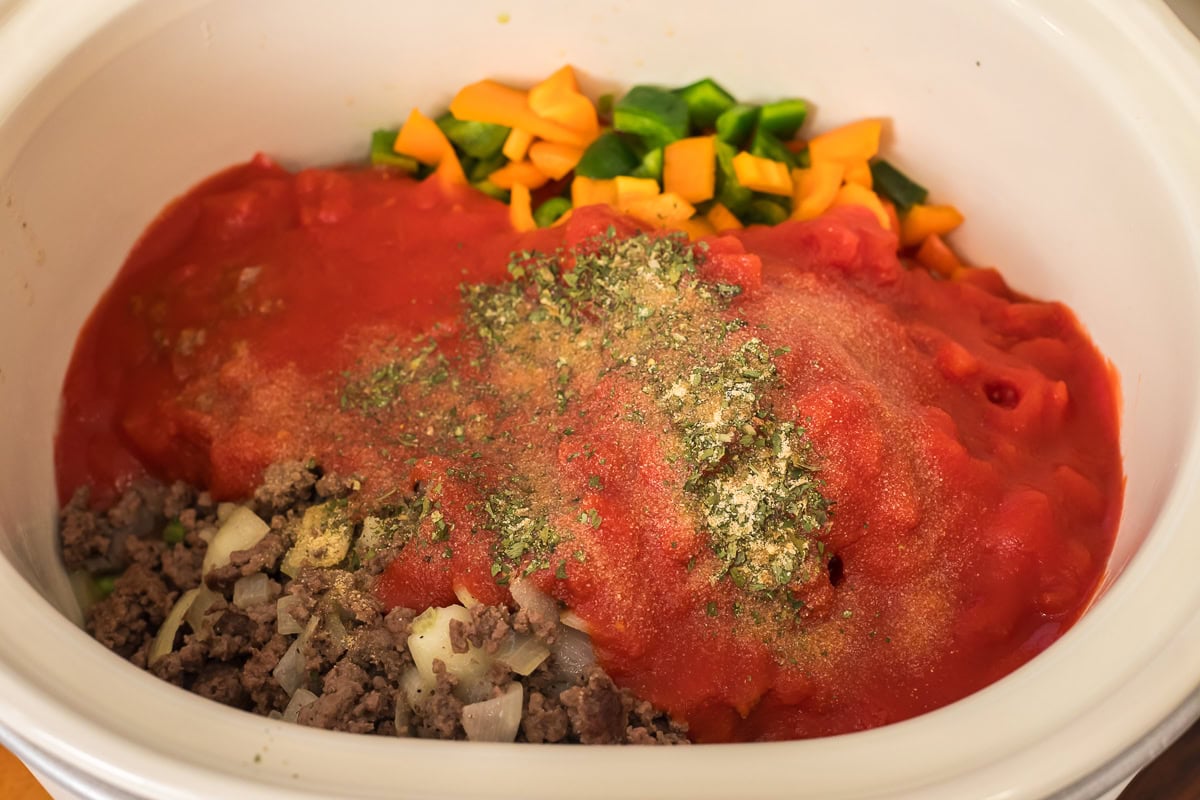 ingredients in slow cooker for stuffed pepper soup recipe.