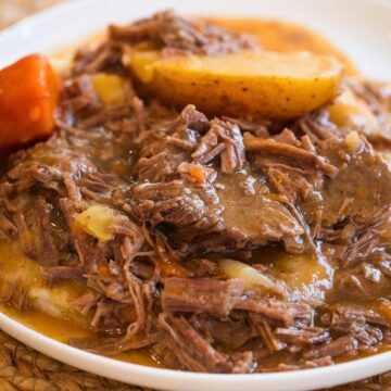 slow cooker top round roast on a white plate.