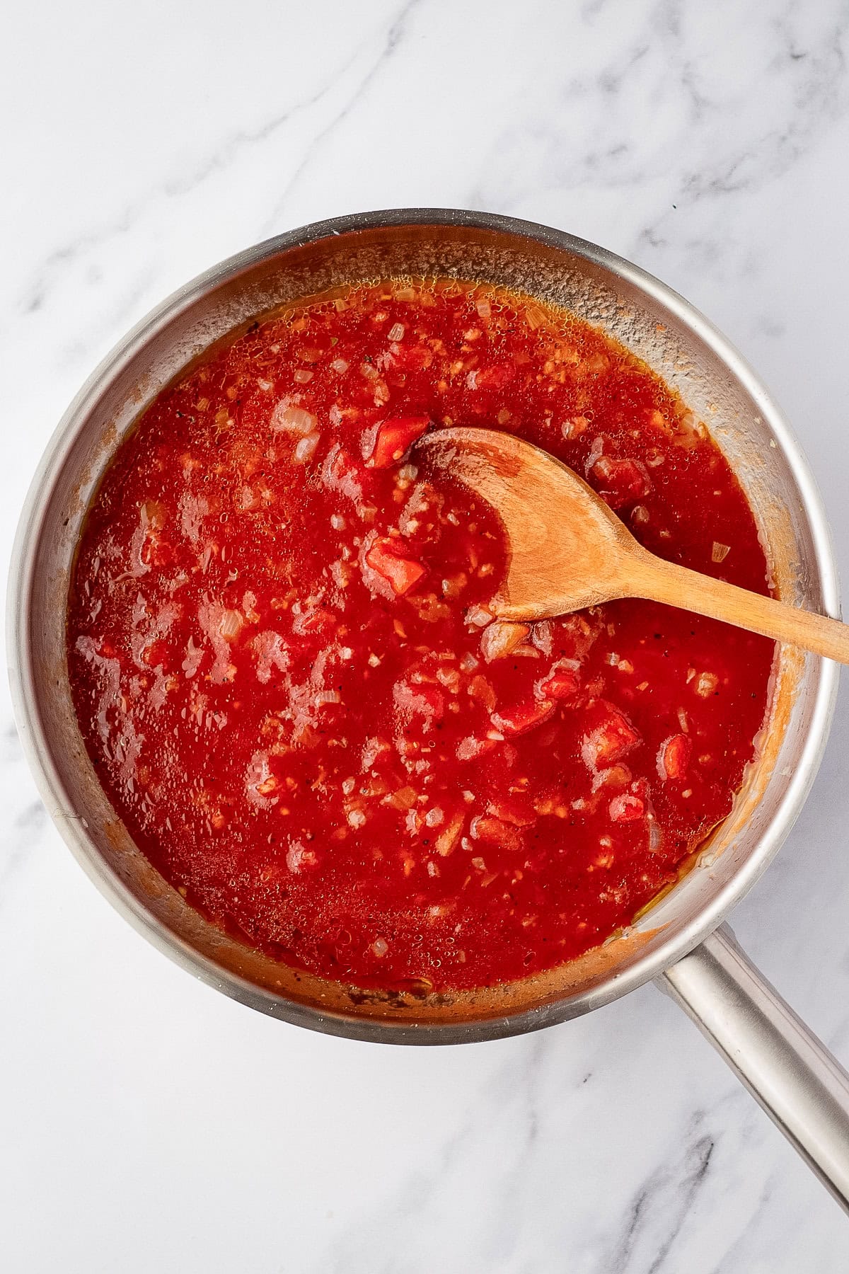 tomato sauce in pan with spoon.