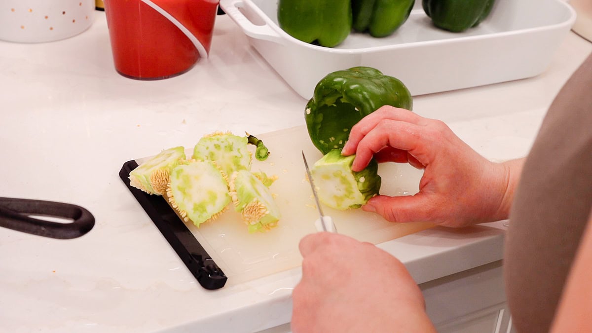 removing seeds from bell peppers and prepping them for stuffing.