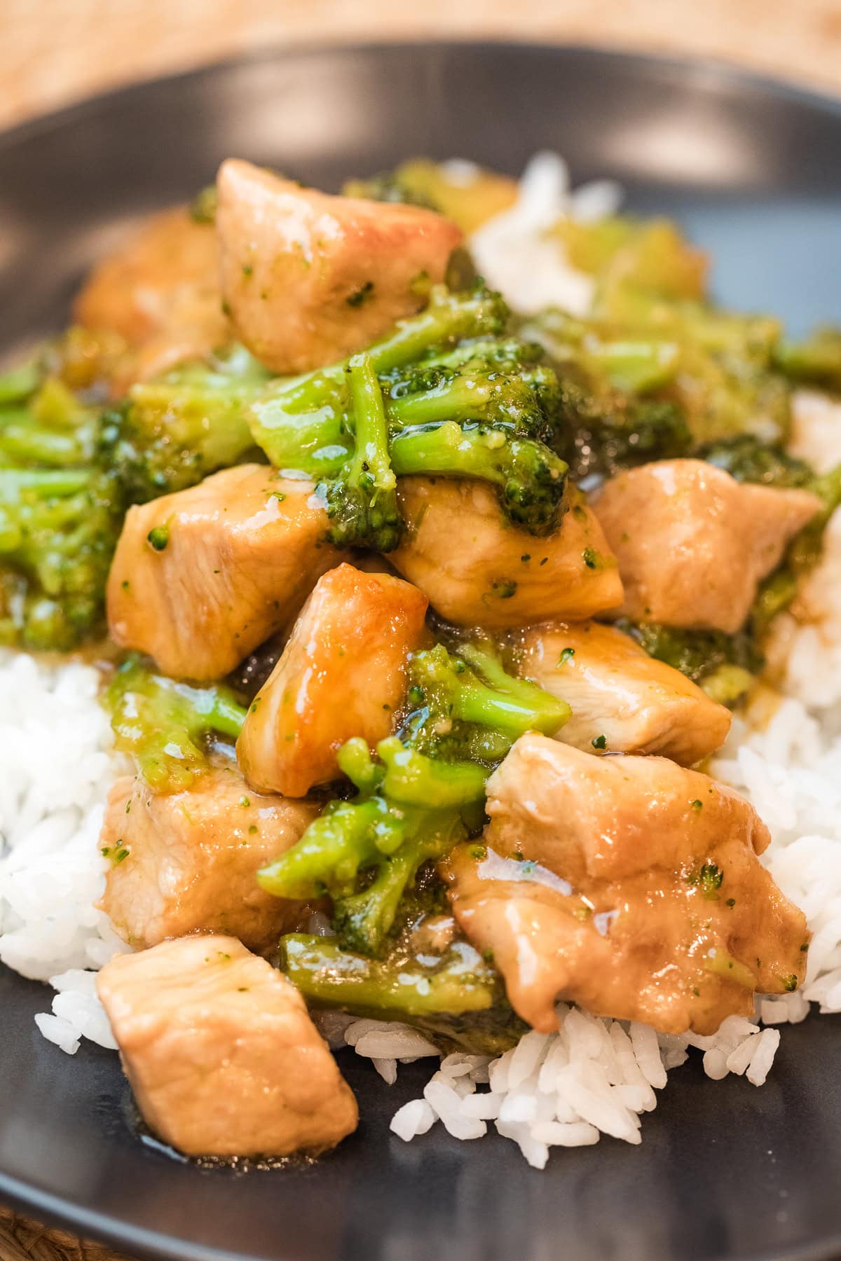 teriyaki pork stir fry over white rice on a plate.