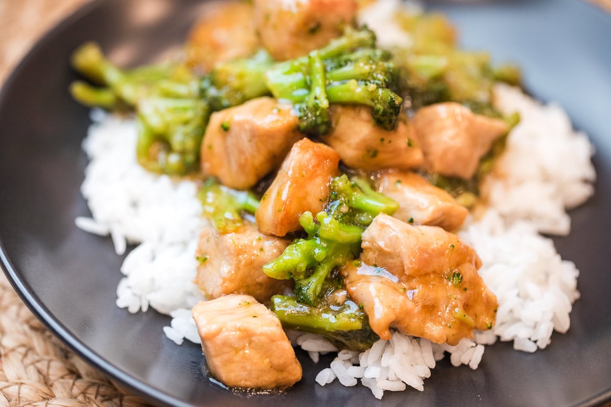 teriyaki pork stir fry on a plate over white rice.