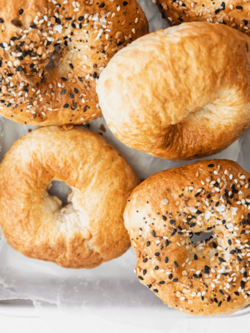 air fryer bagels on a parchment lined pan.