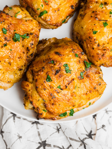 air fryer chicken thighs on a white plate