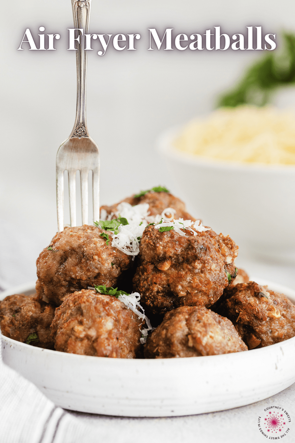 air fryer meatballs in a bowl with a fork sticking into one and text on image for pinterest