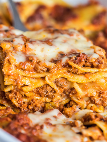 dairy free lasagna without ricotta slice on a metal spatula over the casserole dish.