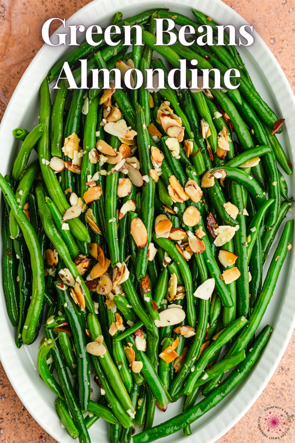 overhead photo of green beans almondine on a white platter with text saying green beans almondine.